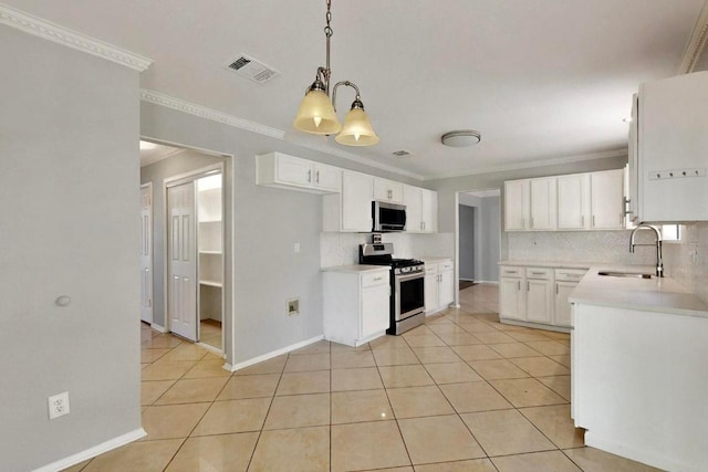 2617 Chowan Cv, Round Rock, TX 78681 - kitchen featuring stainless steel appliances, light tile patterned floors, crown molding, white cabinetry, and pendant lighting