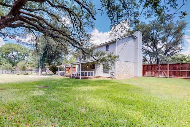 2617 Chowan Cv, Round Rock, TX 78681 - rear view of house featuring stone siding, a chimney, and a deck