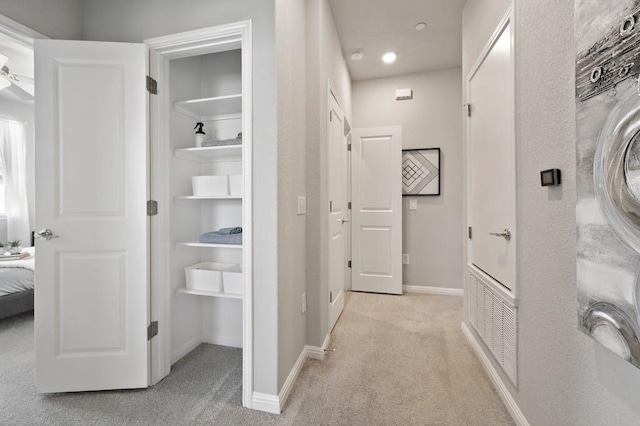 9015 Cattle Baron Path Unit 404, Austin, TX 78747 - hall with light colored carpet, baseboards, built in shelves, and recessed lighting