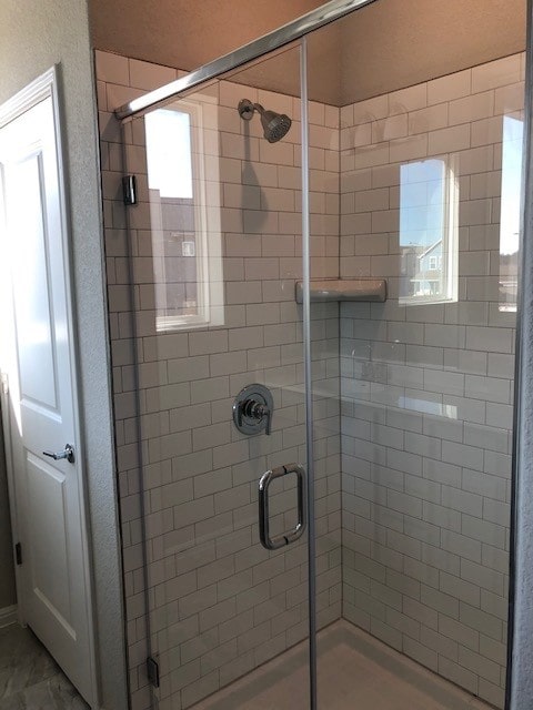 9015 Cattle Baron Path Unit 404, Austin, TX 78747 - full bathroom with a shower stall and plenty of natural light