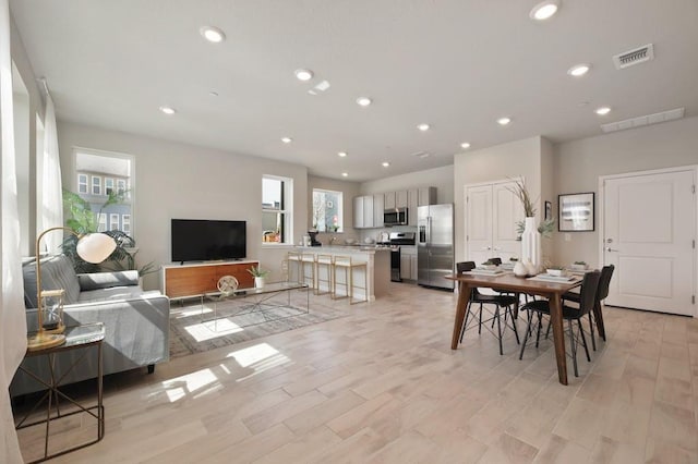 9015 Cattle Baron Path Unit 404, Austin, TX 78747 - living room with healthy amount of natural light, recessed lighting, and light wood-style floors