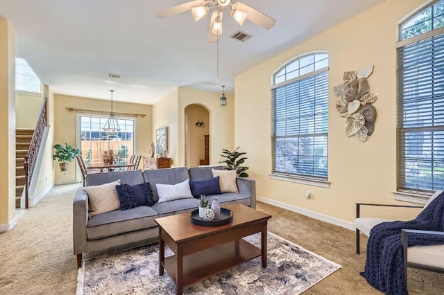 3824 Gaines Ct, Austin, TX 78735 - living area with carpet floors, stairway, arched walkways, and healthy amount of natural light