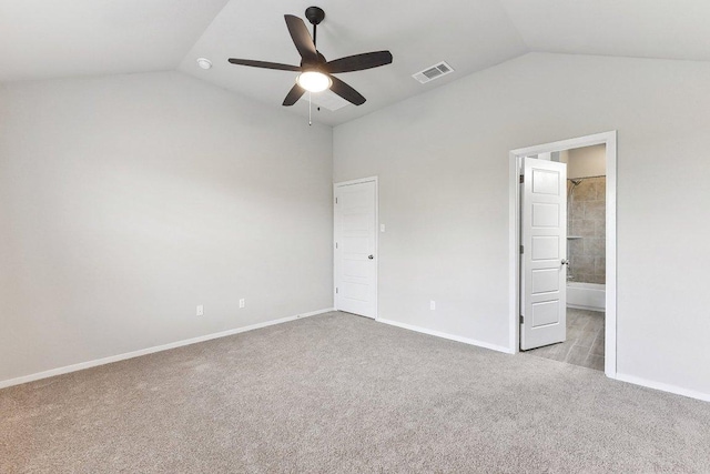 116 Saranac Dr, Elgin, TX 78621 - unfurnished bedroom with vaulted ceiling, carpet, baseboards, connected bathroom, and ceiling fan