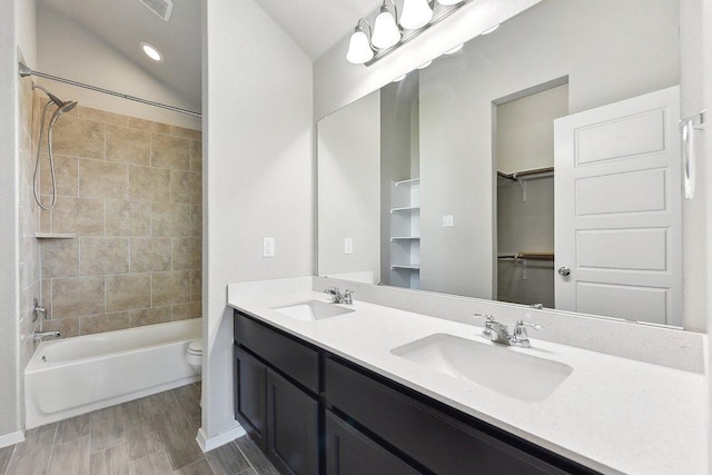 116 Saranac Dr, Elgin, TX 78621 - bathroom featuring double vanity, shower / washtub combination, toilet, and wood finished floors