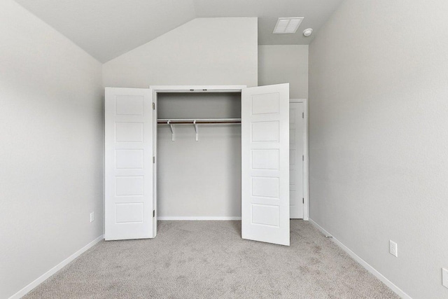 116 Saranac Dr, Elgin, TX 78621 - unfurnished bedroom featuring carpet, vaulted ceiling, a closet, and baseboards