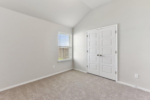 116 Saranac Dr, Elgin, TX 78621 - unfurnished bedroom with vaulted ceiling, light colored carpet, and baseboards