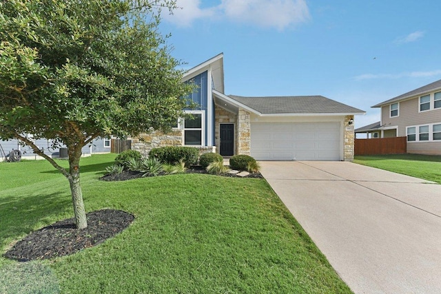 116 Saranac Dr, Elgin, TX 78621 - view of front of house featuring stone siding, a garage, driveway, and a front yard