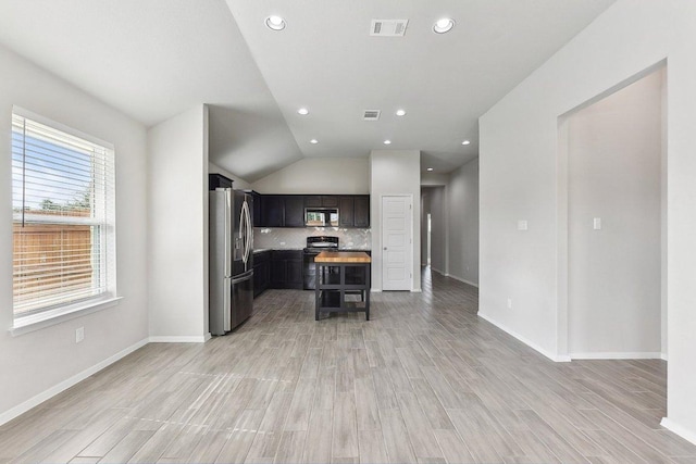 116 Saranac Dr, Elgin, TX 78621 - kitchen featuring stainless steel appliances, open floor plan, lofted ceiling, light countertops, and backsplash