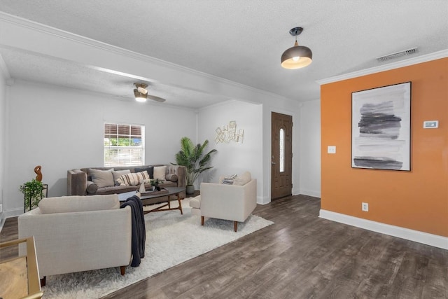 1125 Christie Dr, Austin, TX 78721 - living area with ornamental molding, dark wood-style floors, a textured ceiling, baseboards, and ceiling fan