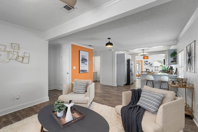 1125 Christie Dr, Austin, TX 78721 - living room with a chandelier, dark wood-type flooring, crown molding, baseboards, and a textured ceiling