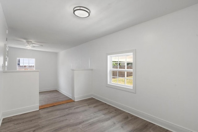 1125 Christie Dr, Austin, TX 78721 - spare room with plenty of natural light, wood finished floors, and ceiling fan