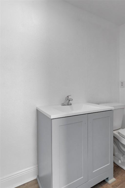 1125 Christie Dr, Austin, TX 78721 - bathroom featuring wood finished floors and vanity