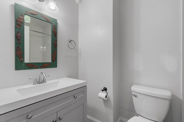 1125 Christie Dr, Austin, TX 78721 - bathroom featuring toilet, vanity, baseboards, and a shower
