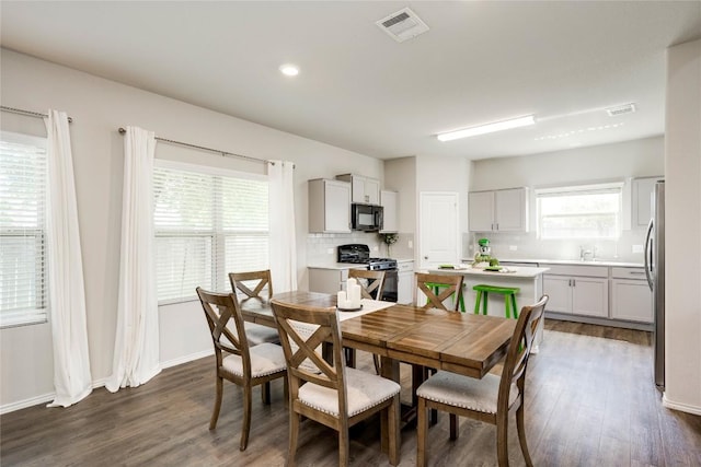 10701 Dimitrios Dr, Austin, TX 78747 - dining space with dark wood finished floors and recessed lighting