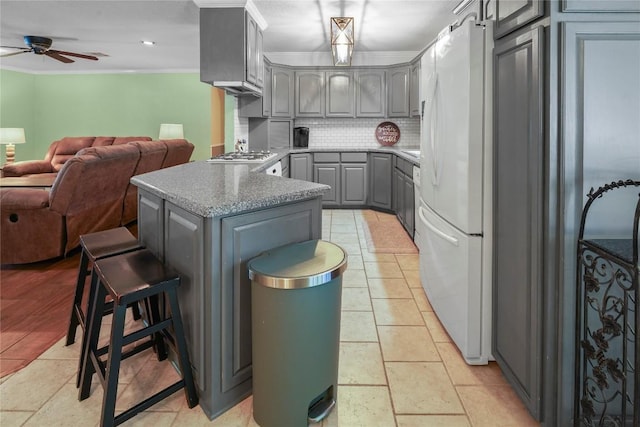 731 Verna Lee Blvd, Harker Heights, TX 76548 - kitchen with gray cabinetry, freestanding refrigerator, open floor plan, a ceiling fan, and tasteful backsplash