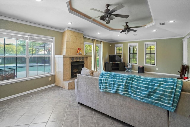 731 Verna Lee Blvd, Harker Heights, TX 76548 - tiled living room with a tray ceiling, healthy amount of natural light, crown molding, recessed lighting, and a ceiling fan