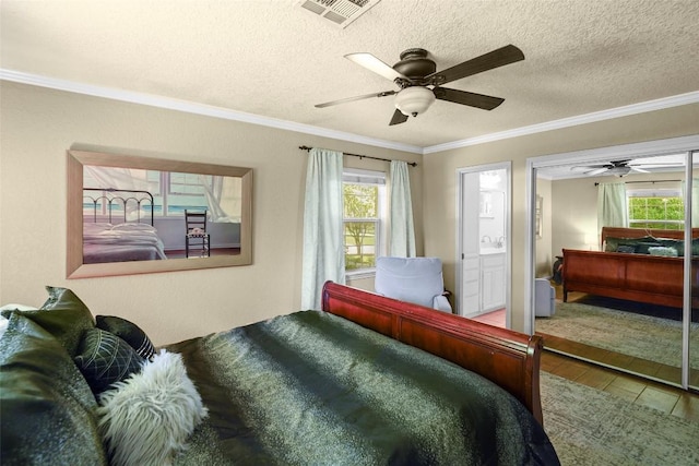 731 Verna Lee Blvd, Harker Heights, TX 76548 - bedroom featuring multiple windows, crown molding, wood finished floors, a textured ceiling, and a ceiling fan