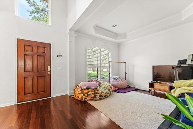 5357 Austral Loop, Austin, TX 78739 - entryway featuring crown molding, wood finished floors, a raised ceiling, baseboards, and ornate columns