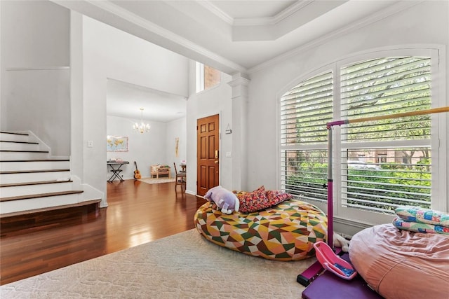 5357 Austral Loop, Austin, TX 78739 - living area with wood finished floors, stairway, a chandelier, and crown molding