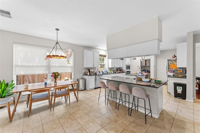 5357 Austral Loop, Austin, TX 78739 - kitchen featuring appliances with stainless steel finishes, dark countertops, a chandelier, and light tile patterned floors