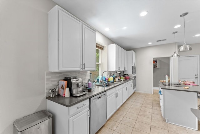 5357 Austral Loop, Austin, TX 78739 - kitchen with stainless steel appliances, decorative backsplash, white cabinets, and recessed lighting