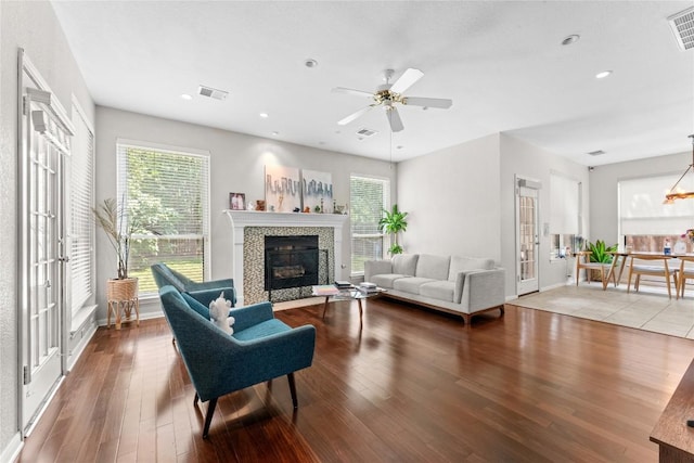 5357 Austral Loop, Austin, TX 78739 - living room with wood finished floors, a tile fireplace, plenty of natural light, ceiling fan, and recessed lighting