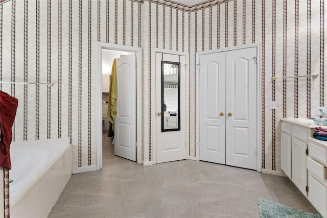 5357 Austral Loop, Austin, TX 78739 - full bathroom with a garden tub, vanity, and wallpapered walls