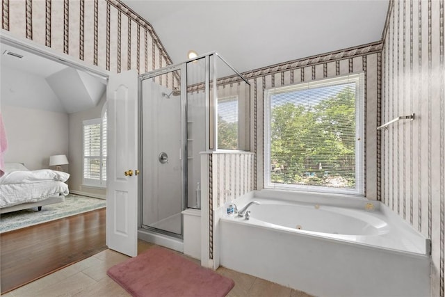 5357 Austral Loop, Austin, TX 78739 - ensuite bathroom with a whirlpool tub, a stall shower, wallpapered walls, lofted ceiling, and tile patterned floors