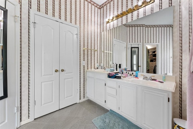5357 Austral Loop, Austin, TX 78739 - full bath with a closet, wallpapered walls, double vanity, and tile patterned floors