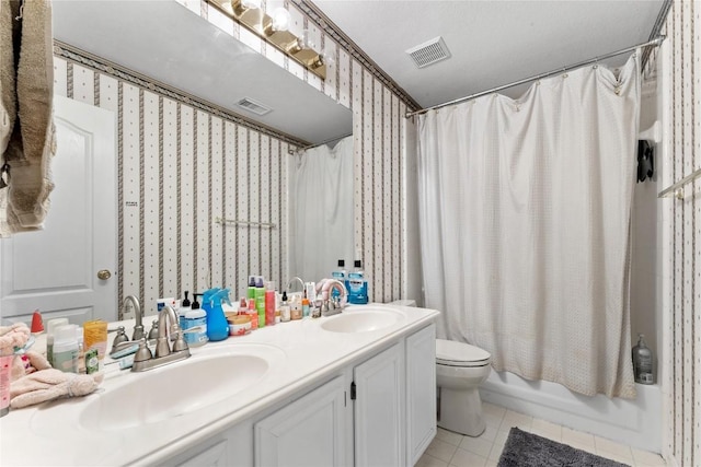 5357 Austral Loop, Austin, TX 78739 - full bathroom with wallpapered walls, toilet, double vanity, tile patterned flooring, and shower / bath combo with shower curtain