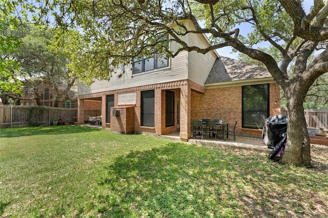 5357 Austral Loop, Austin, TX 78739 - back of house featuring brick siding, a fenced backyard, a patio, and roof with shingles