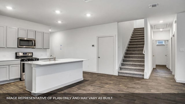 549 Osprey Dr, Leander, TX 78641 - kitchen with stainless steel appliances, a sink, dark wood finished floors, recessed lighting, and light countertops