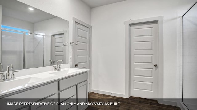 549 Osprey Dr, Leander, TX 78641 - bathroom featuring a stall shower, double vanity, and wood finished floors