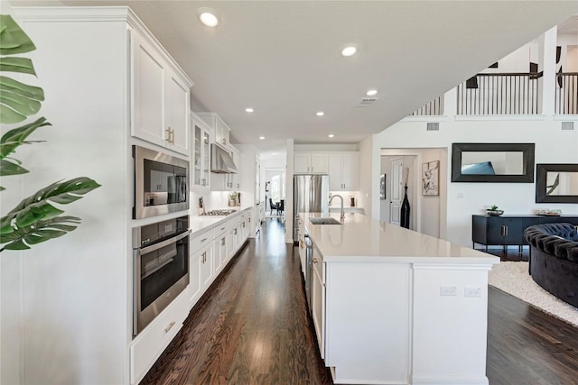 5028 Olimpico Way, Leander, TX 78641 - kitchen featuring stainless steel appliances, a sink, under cabinet range hood, light countertops, and recessed lighting