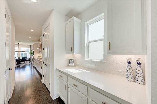 5028 Olimpico Way, Leander, TX 78641 - kitchen featuring light countertops, dark wood-type flooring, tasteful backsplash, recessed lighting, and white cabinetry