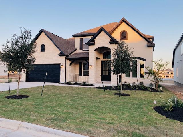 5028 Olimpico Way, Leander, TX 78641 - french provincial home with a front yard, a garage, concrete driveway, and stucco siding