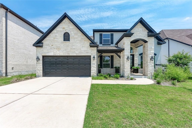 5028 Olimpico Way, Leander, TX 78641 - french country style house with stone siding, driveway, a front yard, and stucco siding