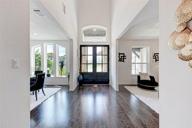 5028 Olimpico Way, Leander, TX 78641 - entrance foyer with dark wood finished floors, baseboards, french doors, and a textured wall
