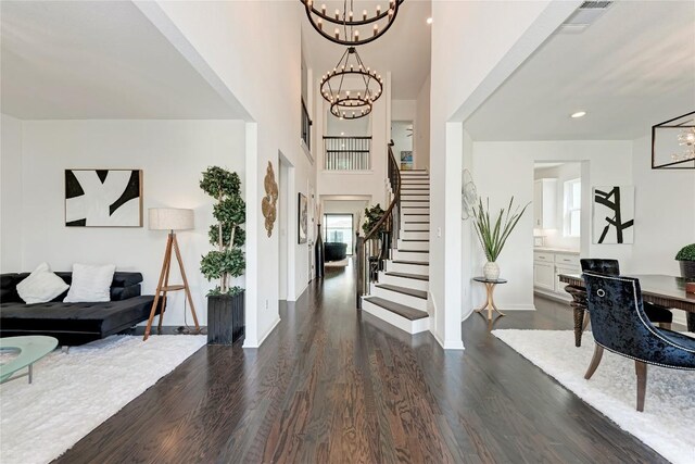 5028 Olimpico Way, Leander, TX 78641 - entryway featuring a chandelier, stairs, dark wood-type flooring, and a high ceiling
