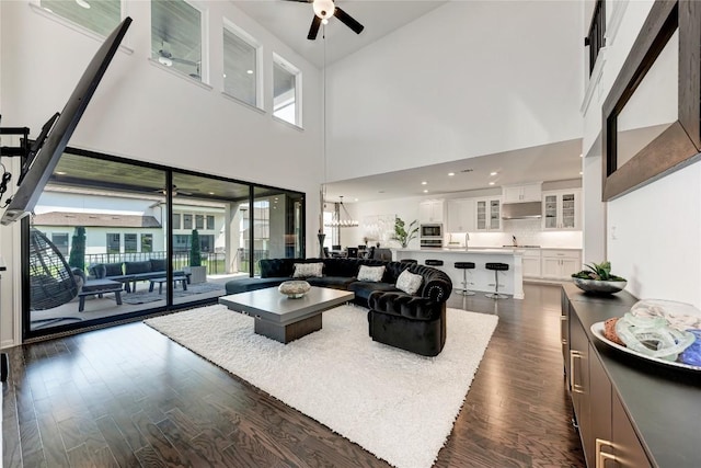 5028 Olimpico Way, Leander, TX 78641 - living room with ceiling fan, dark wood-type flooring, and a high ceiling