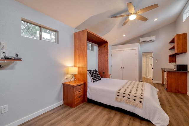 2010 Alguno Rd, Austin, TX 78757 - bedroom featuring a wall mounted AC, light wood-style floors, lofted ceiling, a closet, and ceiling fan