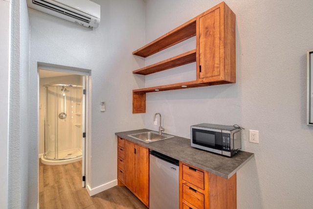2010 Alguno Rd, Austin, TX 78757 - indoor wet bar with dishwasher, a wall unit AC, light wood-type flooring, and baseboards