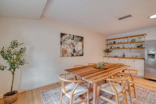 2010 Alguno Rd, Austin, TX 78757 - dining room featuring light wood-style flooring and bar