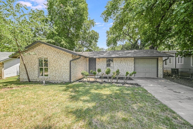 8711 Bridgeport Dr, Austin, TX 78758 - mid-century home with stone siding, an attached garage, concrete driveway, and a front lawn