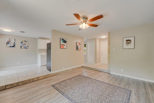8711 Bridgeport Dr, Austin, TX 78758 - spare room featuring ceiling fan, light wood-type flooring, and baseboards
