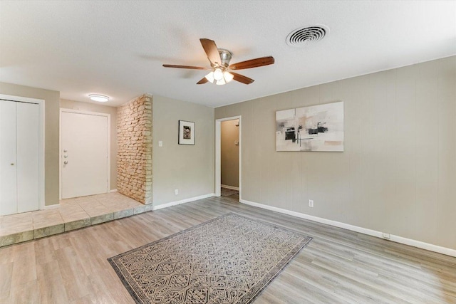 8711 Bridgeport Dr, Austin, TX 78758 - empty room with wood finished floors, ceiling fan, and baseboards