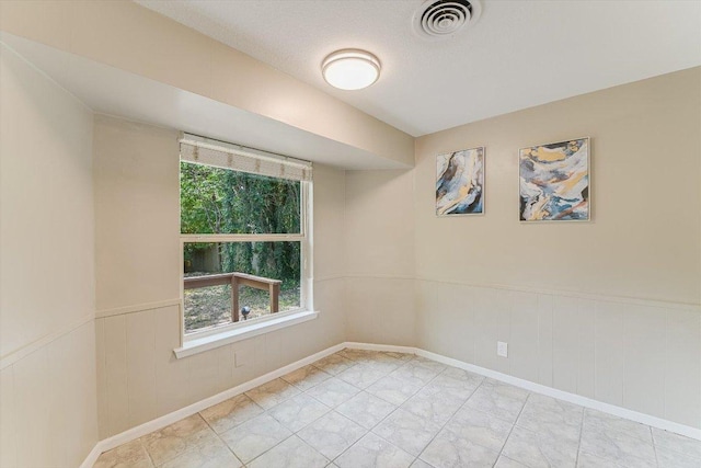 8711 Bridgeport Dr, Austin, TX 78758 - unfurnished room with a wainscoted wall and baseboards