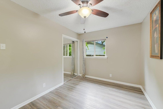 8711 Bridgeport Dr, Austin, TX 78758 - empty room with a textured ceiling, light wood-style flooring, and ceiling fan