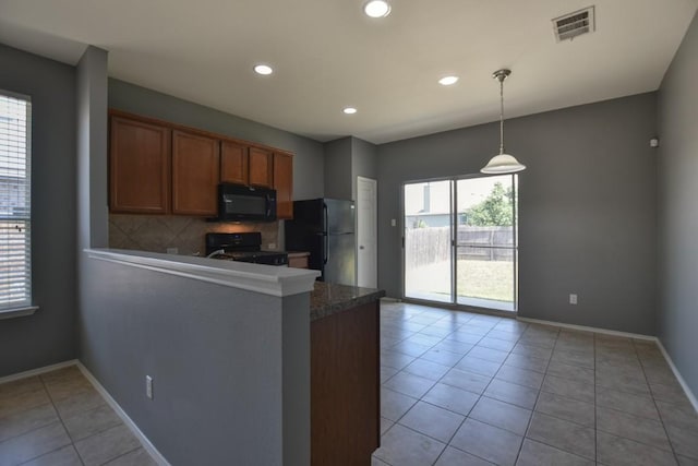 564 Moonwalker Trl, Buda, TX 78610 - kitchen with black appliances, backsplash, a peninsula, light tile patterned floors, and baseboards