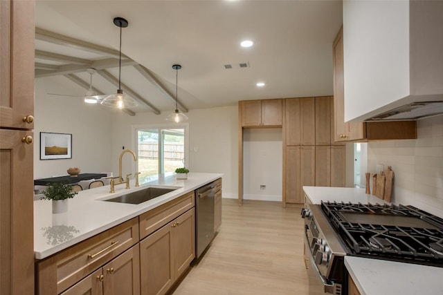 5507 Gloucester Ln, Austin, TX 78723 - kitchen featuring appliances with stainless steel finishes, custom range hood, light wood finished floors, light countertops, and pendant lighting